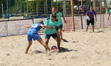ODESSA, UKRAINE July 8, 2021: Ukrainian Beach Soccer Women's Cup. The girl's footballers are desperately playing beach soccer on sand of sea city beach on a hot sunny day. Women's soccer on sandのeditorial素材