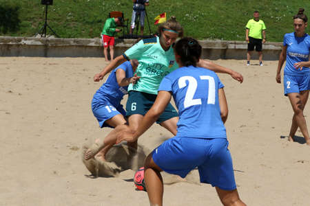 ODESSA, UKRAINE July 8, 2021: Ukrainian Beach Soccer Women's Cup. The girl's footballers are desperately playing beach soccer on sand of sea city beach on a hot sunny day. Women's soccer on sandのeditorial素材