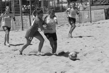ODESSA, UKRAINE July 8, 2021: Ukrainian Beach Soccer Women's Cup. The girl's footballers are desperately playing beach soccer on sand of sea city beach on a hot sunny day. Women's soccer on sandのeditorial素材