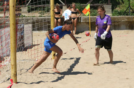 ODESSA, UKRAINE July 8, 2021: Ukrainian Beach Soccer Women's Cup. The girl's footballers are desperately playing beach soccer on sand of sea city beach on a hot sunny day. Women's soccer on sandのeditorial素材