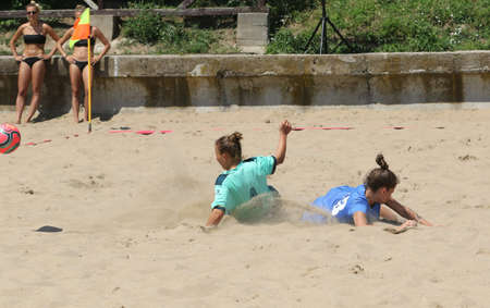 ODESSA, UKRAINE July 8, 2021: Ukrainian Beach Soccer Women's Cup. The girl's footballers are desperately playing beach soccer on sand of sea city beach on a hot sunny day. Women's soccer on sandのeditorial素材