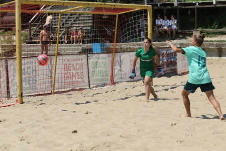 ODESSA, UKRAINE July 8, 2021: Ukrainian Beach Soccer Women's Cup. The girl's footballers are desperately playing beach soccer on sand of sea city beach on a hot sunny day. Women's soccer on sandのeditorial素材
