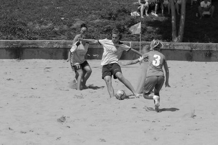 ODESSA, UKRAINE July 8, 2021: Ukrainian Beach Soccer Women's Cup. The girl's footballers are desperately playing beach soccer on sand of sea city beach on a hot sunny day. Women's soccer on sandのeditorial素材