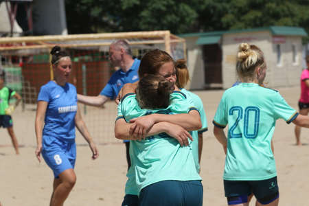 ODESSA, UKRAINE July 8, 2021: Ukrainian Beach Soccer Women's Cup. The girl's footballers are desperately playing beach soccer on sand of sea city beach on a hot sunny day. Women's soccer on sandのeditorial素材