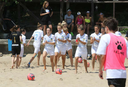 ODESSA, UKRAINE July 8, 2021: Ukrainian Beach Soccer Women's Cup. The girl's footballers are desperately playing beach soccer on sand of sea city beach on a hot sunny day. Women's soccer on sandのeditorial素材