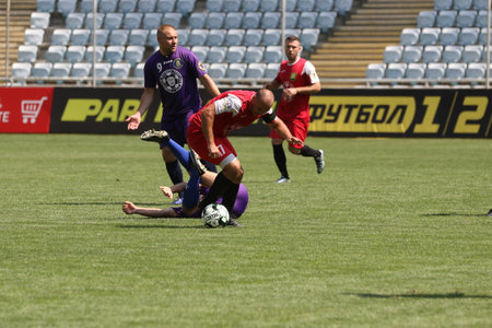 ODESSA, UKRAINE - aug 24, 2021: Football. Traditional Cup of Ukraine among ATO veterans. Veterans play football on green lawn of stadium. Game moment of football fight for cup. Vivid emotions of gameのeditorial素材