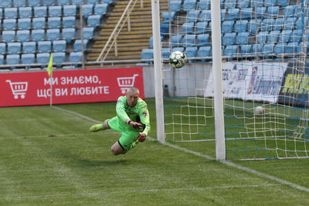 ODESSA, UKRAINE - aug 24, 2021: Football. Traditional Cup of Ukraine among ATO veterans. Veterans play football on green lawn of stadium. Game moment of football fight for cup. Vivid emotions of gameのeditorial素材