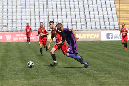 ODESSA, UKRAINE - aug 24, 2021: Football. Traditional Cup of Ukraine among ATO veterans. Veterans play football on green lawn of stadium. Game moment of football fight for cup. Vivid emotions of gameのeditorial素材