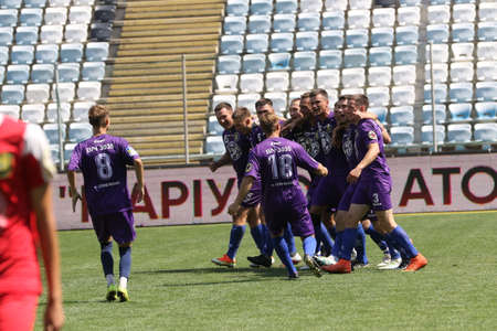 ODESSA, UKRAINE - aug 24, 2021: Football. Traditional Cup of Ukraine among ATO veterans. Veterans play football on green lawn of stadium. Game moment of football fight for cup. Vivid emotions of gameのeditorial素材
