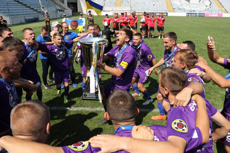 ODESSA, UKRAINE - aug 24, 2021: Football. Traditional Cup of Ukraine among ATO veterans. Veterans play football on green lawn of stadium. Game moment of football fight for cup. Vivid emotions of gameのeditorial素材