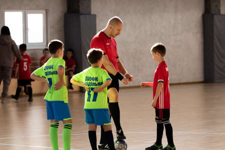 ODESSA, UKRAINE - oct 14, 2021: Little boys 8-9 years, children play mini-football in sports hall at Ukrainian Championship. Children's sports are healthy lifestyle. Boy sport soccer players futsalのeditorial素材
