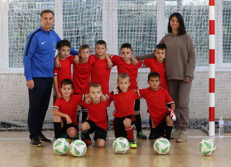 ODESSA, UKRAINE - oct 14, 2021: Little boys 8-9 years, children play mini-football in sports hall at Ukrainian Championship. Children's sports are healthy lifestyle. Boy sport soccer players futsalのeditorial素材