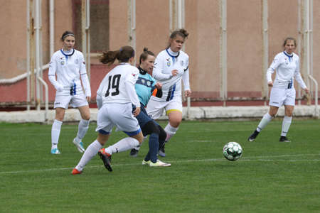 ODESSA, UKRAINE -31 DECEMBER 2021: Women's football on grass field of stadium. Football Championship among women White - FC Chernomorets Odessa - Yunost Chernigov. Game moment of girls footballのeditorial素材