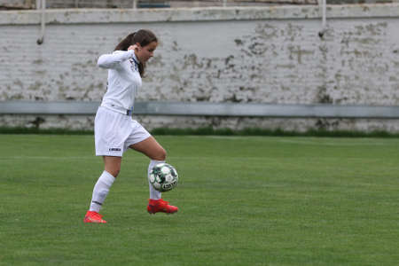 ODESSA, UKRAINE -31 DECEMBER 2021: Women's football on grass field of stadium. Football Championship among women White - FC Chernomorets Odessa - Yunost Chernigov. Game moment of girls footballのeditorial素材