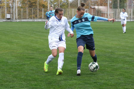 ODESSA, UKRAINE -31 DECEMBER 2021: Women's football on grass field of stadium. Football Championship among women White - FC Chernomorets Odessa - Yunost Chernigov. Game moment of girls footballのeditorial素材