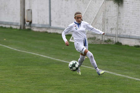 ODESSA, UKRAINE -31 DECEMBER 2021: Women's football on grass field of stadium. Football Championship among women White - FC Chernomorets Odessa - Yunost Chernigov. Game moment of girls footballのeditorial素材