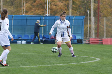 ODESSA, UKRAINE -31 DECEMBER 2021: Women's football on grass field of stadium. Football Championship among women White - FC Chernomorets Odessa - Yunost Chernigov. Game moment of girls footballのeditorial素材
