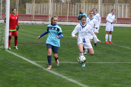 ODESSA, UKRAINE -31 DECEMBER 2021: Women's football on grass field of stadium. Football Championship among women White - FC Chernomorets Odessa - Yunost Chernigov. Game moment of girls footballのeditorial素材