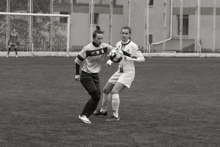 ODESSA, UKRAINE -31 DECEMBER 2021: Women's football on grass field of stadium. Football Championship among women White - FC Chernomorets Odessa - Yunost Chernigov. Game moment of girls footballのeditorial素材