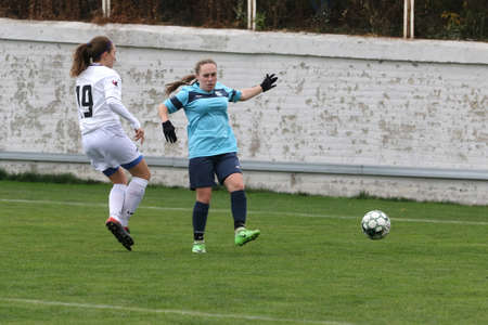 ODESSA, UKRAINE -31 DECEMBER 2021: Women's football on grass field of stadium. Football Championship among women White - FC Chernomorets Odessa - Yunost Chernigov. Game moment of girls footballのeditorial素材