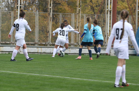 ODESSA, UKRAINE -31 DECEMBER 2021: Women's football on grass field of stadium. Football Championship among women White - FC Chernomorets Odessa - Yunost Chernigov. Game moment of girls footballのeditorial素材