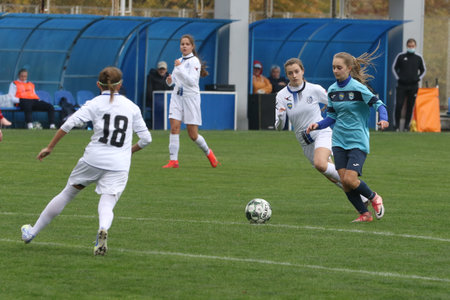 ODESSA, UKRAINE -31 DECEMBER 2021: Women's football on grass field of stadium. Football Championship among women White - FC Chernomorets Odessa - Yunost Chernigov. Game moment of girls footballのeditorial素材