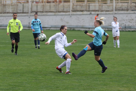 ODESSA, UKRAINE -31 DECEMBER 2021: Women's football on grass field of stadium. Football Championship among women White - FC Chernomorets Odessa - Yunost Chernigov. Game moment of girls footballのeditorial素材