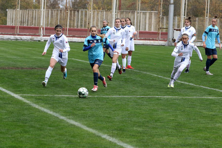 ODESSA, UKRAINE -31 DECEMBER 2021: Women's football on grass field of stadium. Football Championship among women White - FC Chernomorets Odessa - Yunost Chernigov. Game moment of girls footballのeditorial素材
