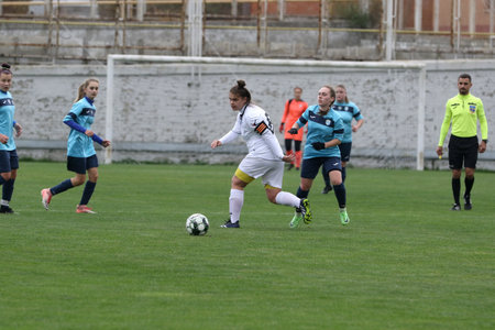 ODESSA, UKRAINE -31 DECEMBER 2021: Women's football on grass field of stadium. Football Championship among women White - FC Chernomorets Odessa - Yunost Chernigov. Game moment of girls footballのeditorial素材