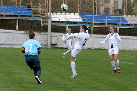 ODESSA, UKRAINE -31 DECEMBER 2021: Women's football on grass field of stadium. Football Championship among women White - FC Chernomorets Odessa - Yunost Chernigov. Game moment of girls footballのeditorial素材
