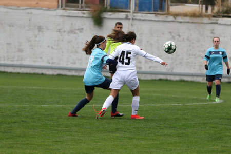 ODESSA, UKRAINE -31 DECEMBER 2021: Women's football on grass field of stadium. Football Championship among women White - FC Chernomorets Odessa - Yunost Chernigov. Game moment of girls footballのeditorial素材