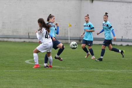 ODESSA, UKRAINE -31 DECEMBER 2021: Women's football on grass field of stadium. Football Championship among women White - FC Chernomorets Odessa - Yunost Chernigov. Game moment of girls footballのeditorial素材