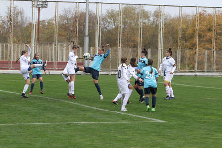 ODESSA, UKRAINE -31 DECEMBER 2021: Women's football on grass field of stadium. Football Championship among women White - FC Chernomorets Odessa - Yunost Chernigov. Game moment of girls footballのeditorial素材