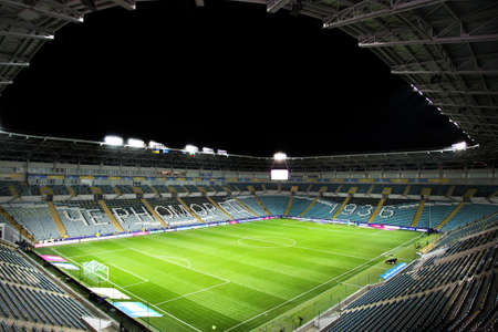 ODESSA, UKRAINE - November 11, 2021: ChMP Stadium before game between national teams of Ukraine and Bulgaria. Panoramic views of football arena with natural grass lawn for 36,000 spectators at nightのeditorial素材