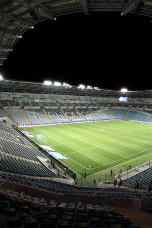 ODESSA, UKRAINE - November 11, 2021: ChMP Stadium before game between national teams of Ukraine and Bulgaria. Panoramic views of football arena with natural grass lawn for 36,000 spectators at nightのeditorial素材