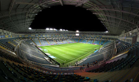 ODESSA, UKRAINE - November 11, 2021: ChMP Stadium before game between national teams of Ukraine and Bulgaria. Panoramic views of football arena with natural grass lawn for 36,000 spectators at nightのeditorial素材