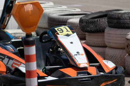 ODESSA, UKRAINE - June 18, 2022: Karting. Go Kart on track. Young positive girl racer in a helmet...