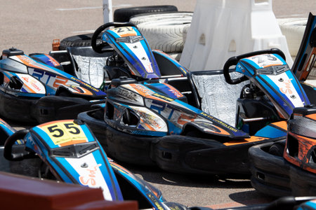ODESSA, UKRAINE - June 18, 2022: Karting. Go Kart on track. Young positive girl racer in a helmet driving kart during car race on an auto track outdoors. extreme auto sport in sports clubのeditorial素材