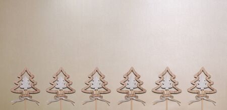 Six Christmas trees made of wood on gold table top view.の写真素材