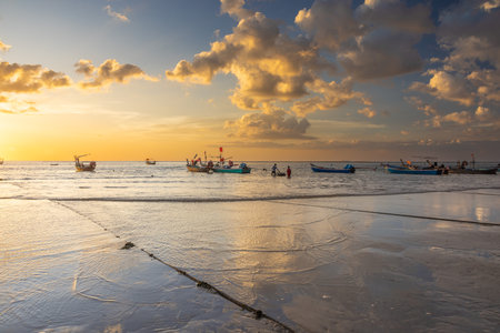 Late day lights at sunset on Naiyang Beach in the northwest of the island of Phuket in Thailand.の写真素材