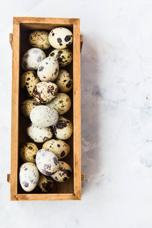 Quail eggs in a wooden boxの写真素材