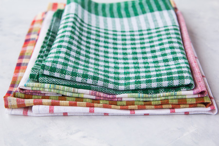 Colorful towels for the kitchen lie in a pileの写真素材