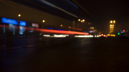 The bright lights of the city at night, the headlights of the approaching cars on the roadの写真素材