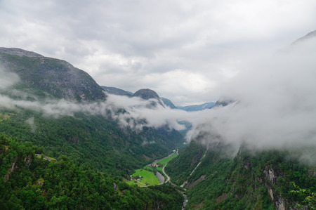 Norwegian highland and valley covered by low density cloudsの写真素材