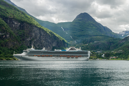 Cruise ship standing near Geiranger town Norwayのeditorial素材