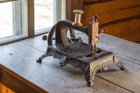 Old vintage sewing machine on wooden tableの写真素材