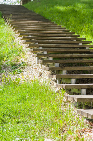 Wooden plank vanishing stair outdoor in springtime parkの写真素材