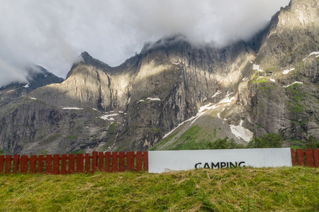 Camping area signboard near pedestal of high rocksの写真素材