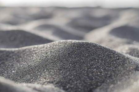 Volcanic black sand abstract and blurred closeupの写真素材