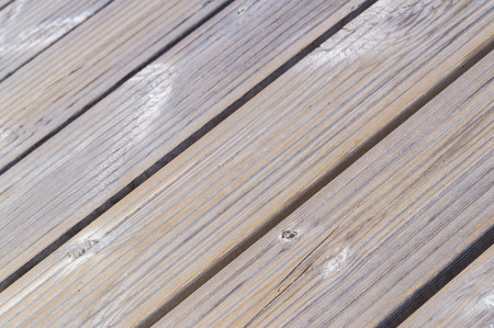 Diagonal closeup on beige wooden planks floorの写真素材
